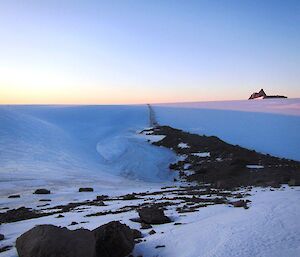 An icy amphitheater with a frozen lake below the summit of Mt Hordern. Leading away from the frozen lake is a natrually occuring moraine trail