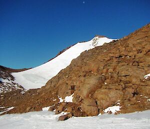 The sloping snow and scree approach leading from the campsite up to the East summit of Mt Hordern