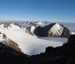 Standing beneath the summit of Mt Hordern and looking across the Antarctic plateau. Mt Dunlop is in the foreground whilst other unnamed peaks lay scattered across the plateau