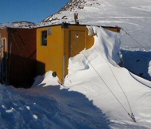 Colbeck hut covered in snow and ice before being dug out and towed back to station