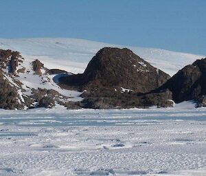 Looking across the frozen ice toward the rocky outcrop of Tilly Nunatuk