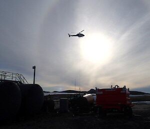 A helicopter sling loading during resupply