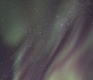 An aurora streaking across the sky above Macey Hut