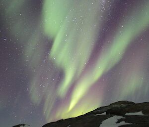 A green and pink aurora over Macey Island