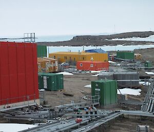 Mawson station as looking north from the top of the station and looking past the red shed and toward the yellow Operations building