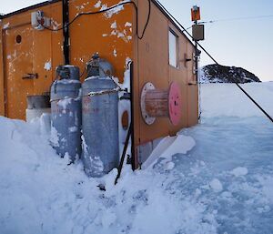 The Colbeck Hut as it was when the team arrived, stuck fast in the ice