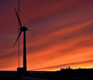 Midnight at Mawson research station with the sky glowing orange