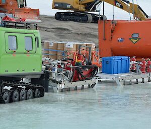 A Hägglunds and it’s two trailers, which are hitched in tandem, which are parked on the sea ice near station begin to melt into the ice due to the recent spell of sunning weather