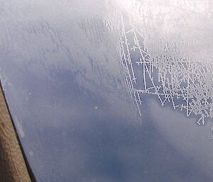 Ice crystals busily growing in a wonderous maze of formations on the inside of the aircraft’s window