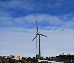 Garry pictured on the transmission mast cleaning the web cam with the wind turbine pictured in the background