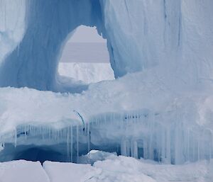 A hole in a large iceberg looks like a cave entrance