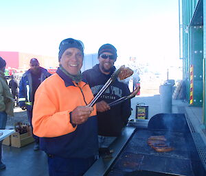 Two expeditioners cooking a BBQ on Chrsitmas Eve