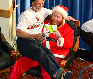 An expeditioner sitting on Santa’s knee