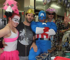Expeditioners in fancy superhero dress in the kitchen
