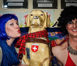 Two expeditioners posing for a photograph with Stay the mascot dog.