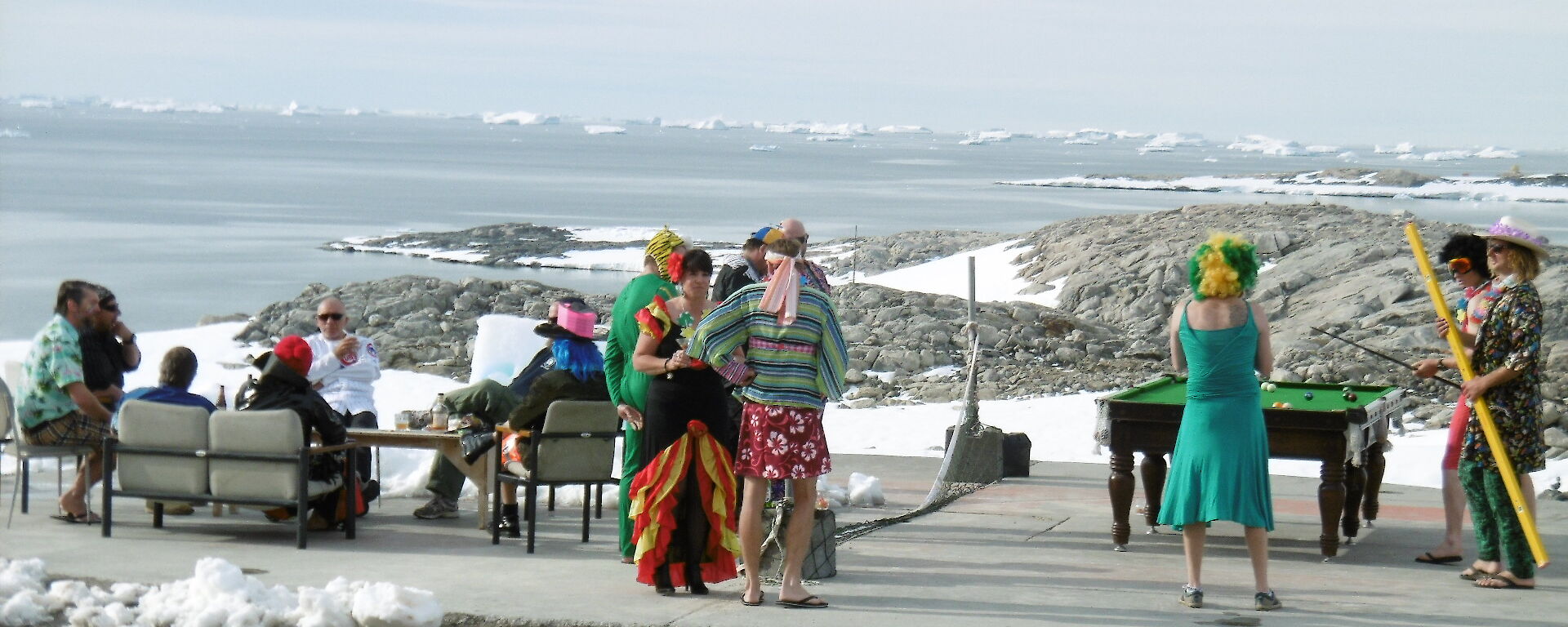 Pool table set up on the helicopter pad and expeditioners playing pool