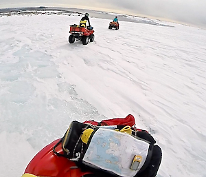 A rider of a quad bike taking a photo of his three fellow expeditioners on their quad bikes