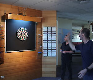 A dart player throwing a dart