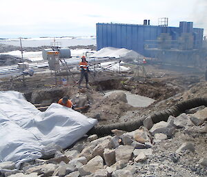 Concrete poured into dug foundations for the new fuel tank at a building site