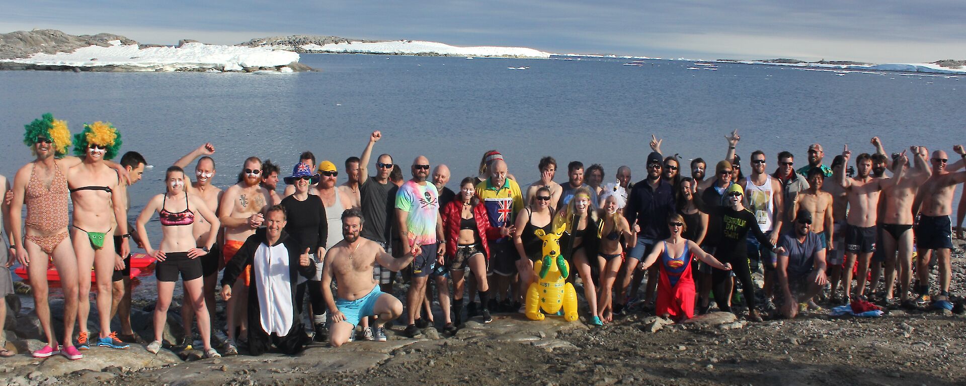 Fifty two swimmers pose for a photo wearing there swim gear before the plunge
