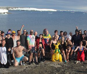 Fifty two swimmers pose for a photo wearing there swim gear before the plunge