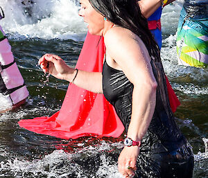 A female expeditioner running out of the water
