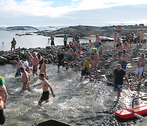 Expeditioners entering the water with one making a quick U turn.