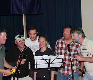 Six Canadian expeditioners singing with the band