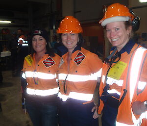 Three women expeditioners dressed up in protective clothing