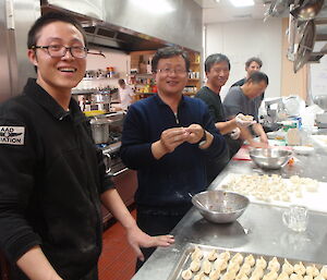 A group of Chinese expeditioners cooking in the kitchen