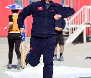 A Chinese expeditioner playing cricket