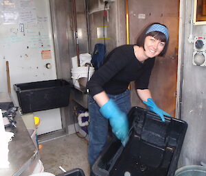 A female expeditioner cleaning a bucket
