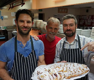 Three expeditioners with a plate of apple strudel