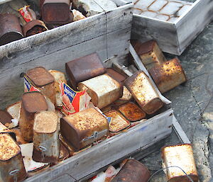 Some old food in cans exposed by the melt