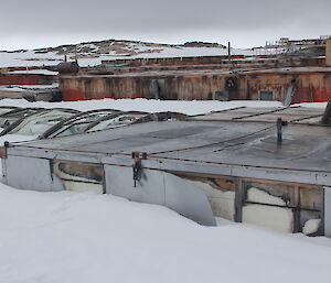 Tops of old buildings sticking out of the snow