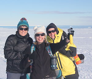 Three expeditioners taking a selfie photograph