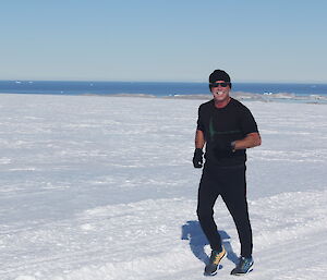 An expeditioner running on snow in the KBA challenge