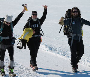 Three expeditioners walking on snow