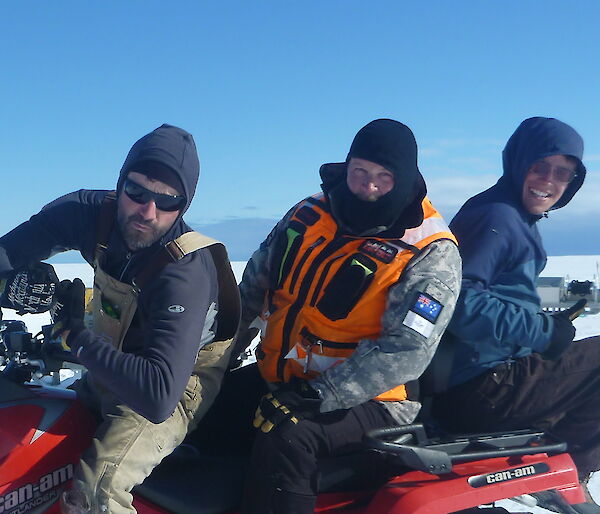 Three expedtioners on a skidoo