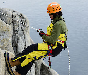 Expedtioner absailing down a cliff face