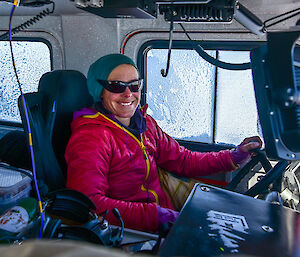 A female expedtioner behind the wheel of a Hagglund