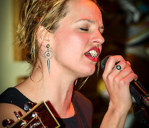 Close up of female singing in a band