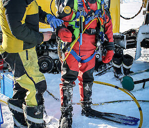 Diver is checked by assistant before entering the water