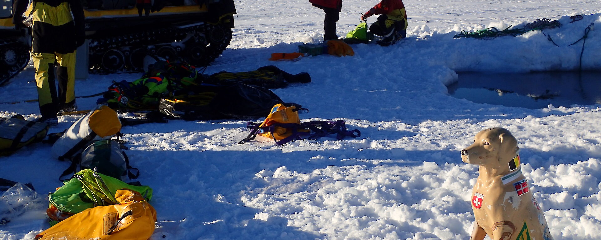 Station mascot, plastic dog Stay, in front of ice hole