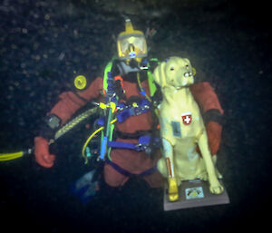 Antarctic mascot stay the dog, under sea ice with diver