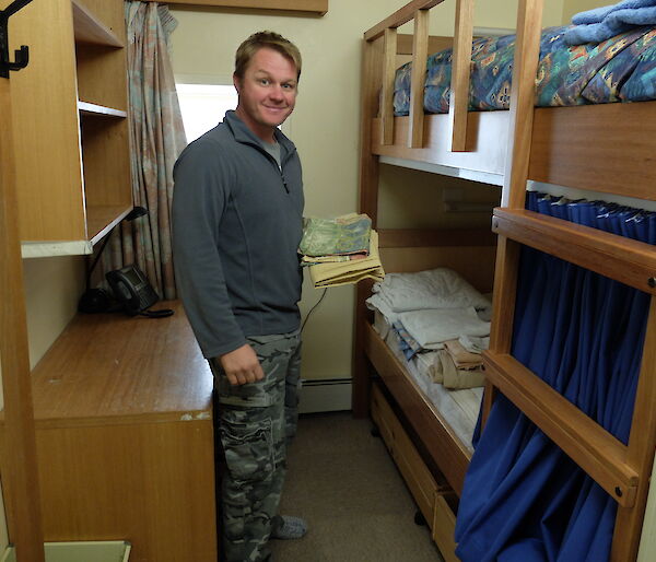 Expeditioner cleans bedrooms in preperation for next season