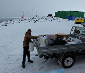 Expeditioner loads truck with excess clothing