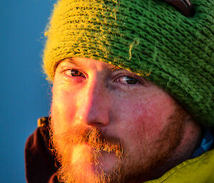 Expeditioner at sunset with emotion in his eyes and sun shining on his face