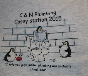 T-shirt with fake plumbing logo that reads “C&N Plumbing, Casy station 2015” and shows penguins trying to fix a toilet with a giant ice cube in the bowl