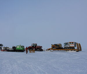 Drivers rest on way back to station in a long convoy of vehicles on the ice